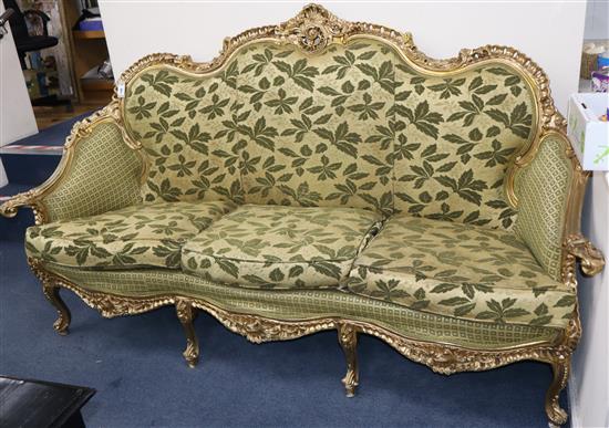 A Louis XVI style giltwood three seater carved settee W.206cm